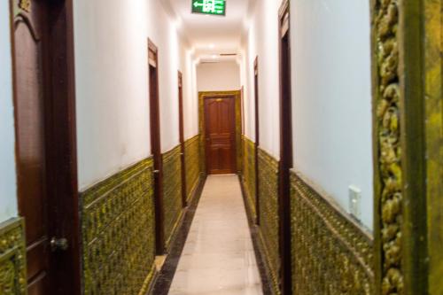 an empty corridor of a building with a door at Le Hotel Hotel Phnom Penh in Phnom Penh