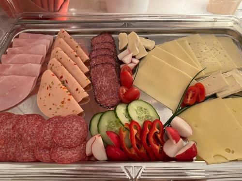 a tray of different types of meats and cheese at Hotel Sonne in Wolfach