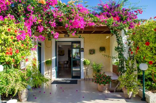 an entrance to a building with lots of flowers at Your Memories Hotel in Gouves