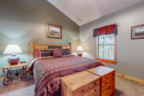 a bedroom with a large bed and a window at Cozy Cub Cabin in Gatlinburg