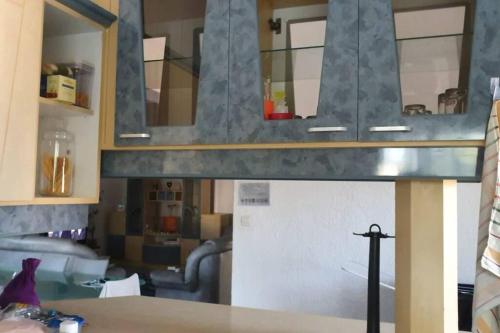 a view of a room with a kitchen and a table at Appartment et piscine in Flic-en-Flac