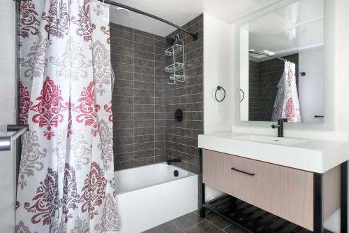 a bathroom with a sink and a shower curtain at SoMa 1br w rooftop bbq concierge nr Bart SFO-1431 in San Francisco