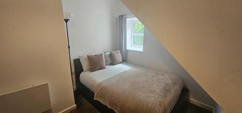 a small bed in a small room with a window at City Blessed Aptm 5 with free parking in South Shields
