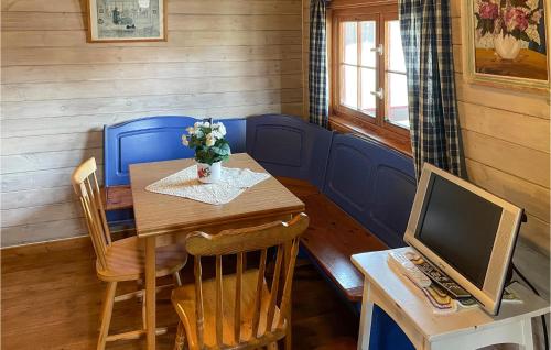 a dining room with a table and a computer at Pet Friendly Home In Grue Finnskog With Wifi in Svullrya
