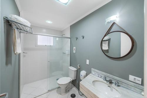 a bathroom with a shower and a toilet and a mirror at Capcana Hotel Jardins in Sao Paulo