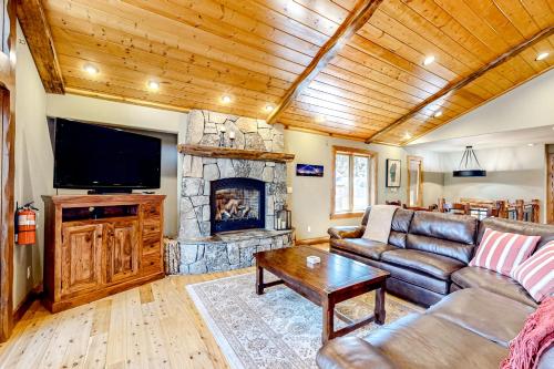 a living room with a couch and a fireplace at Log Luxury in Tahoe Vista
