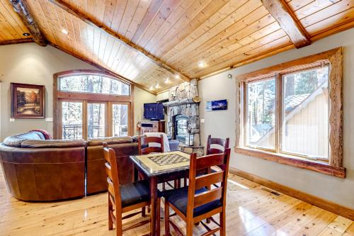 a living room with a couch and a table and chairs at Log Luxury in Tahoe Vista