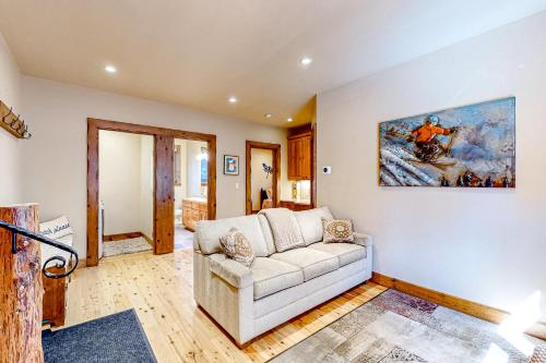 a living room with a couch and a painting on the wall at Log Luxury in Tahoe Vista