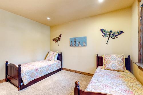 a bedroom with two beds and butterflies on the wall at Log Luxury in Tahoe Vista