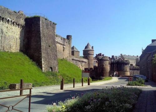 a street in front of a large castle at House at the foot of the castle of Fougeres in Fougères