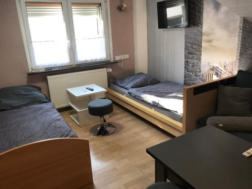 a small room with two beds and a couch at Monteur &,Geschäftsreisen Stay in Günsterode