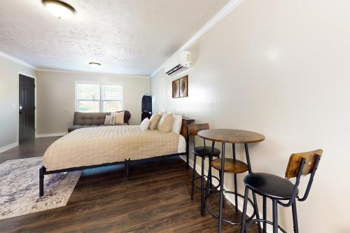 a bedroom with a bed and a table at Alcove On Central in La Follette