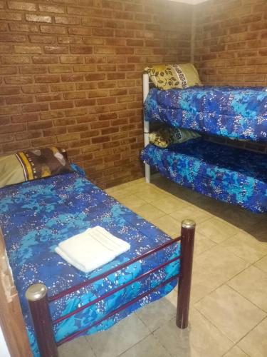 a room with two bunk beds and a table at Complejo Hatun Yaya in Mendoza