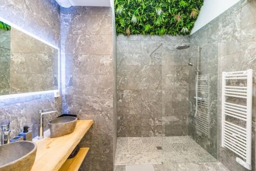 a bathroom with a shower and a sink at Charmante longère proche des côtes de granit rose in Lannion