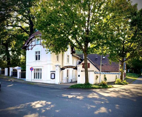 a white house on the side of a street at Kaisermühle Hotel & Gasthof in Viersen