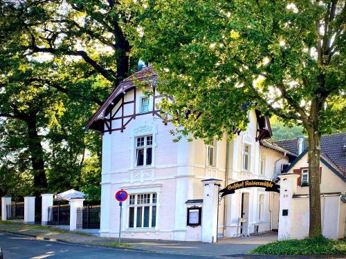 a large white house on the side of a street at Kaisermühle Hotel & Gasthof in Viersen