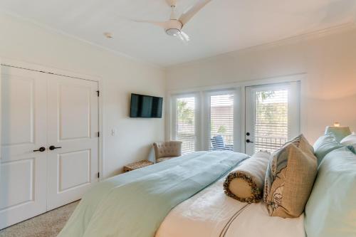 a bedroom with a large bed with pillows on it at Luxe Jekyll Island Home with Beach and Pool Access in Jekyll Island
