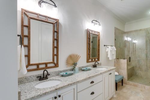 a bathroom with two sinks and a shower at Luxe Jekyll Island Home with Beach and Pool Access in Jekyll Island