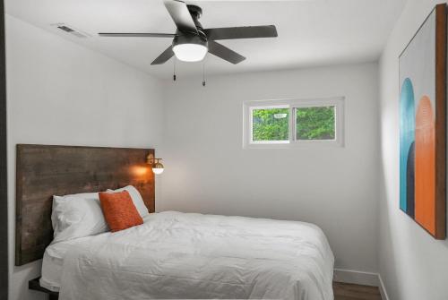 a bedroom with a bed with a ceiling fan at Alhonna Resort in Lake Ozark