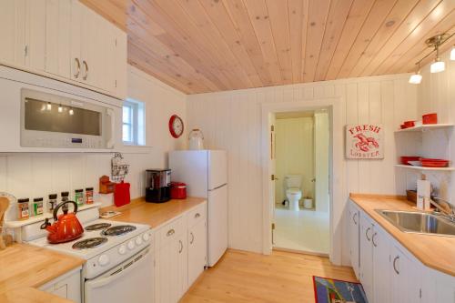 a kitchen with white appliances and a wooden ceiling at Beachfront Brooklin Studio with Private Balcony! in Brooklin