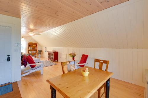 a living room with a wooden table and chairs at Beachfront Brooklin Studio with Private Balcony! in Brooklin