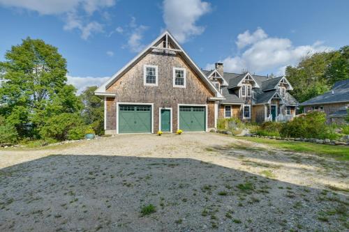 a large brick house with green garage doors at Beachfront Brooklin Studio with Private Balcony! in Brooklin