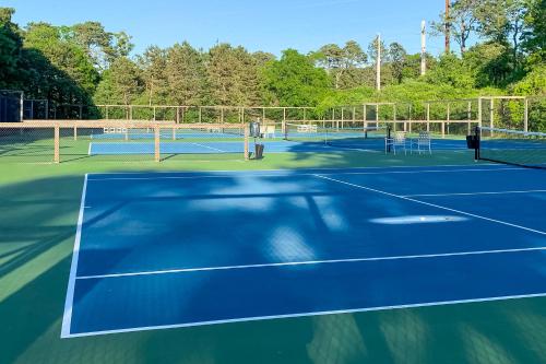 a tennis court with two tennis courts at Sand, Shells & Sunsets in Brewster