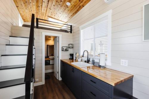a kitchen with a sink and a wooden ceiling at Jasper tiny home with private hottub in Apple Valley