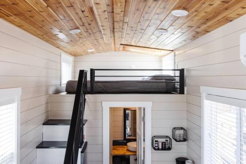 a tiny house with a bunk bed on the ceiling at Jasper tiny home with private hottub in Apple Valley