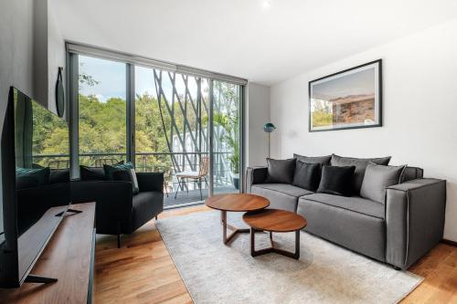 a living room with a couch and a table at New Apartments La Condesa by VIATO in Mexico City