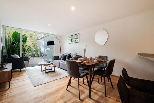 a living room with a table and a couch at New Apartments La Condesa by VIATO in Mexico City