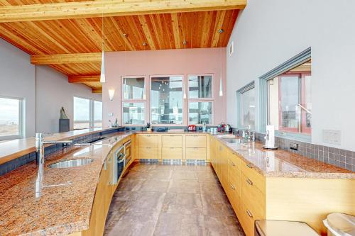 a large kitchen with two sinks and windows at Pacific Bliss Haven in Gualala