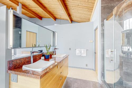a bathroom with two sinks and a mirror at Pacific Bliss Haven in Gualala