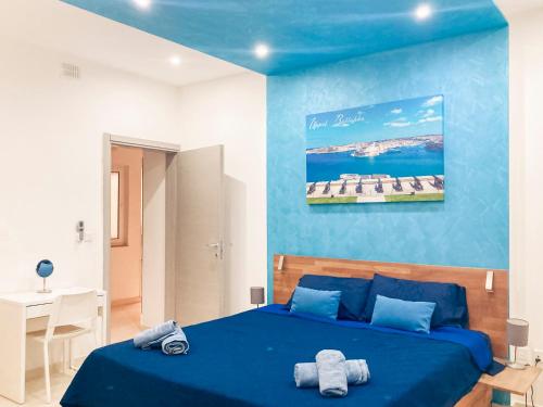 a blue bedroom with a bed with towels on it at Valletta and Grand Harbour Lookout in Kalkara