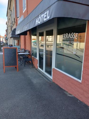 a hotel with a sign in front of a building at Hôtel Restaurant O REGAL in Villeneuve-sur-Lot