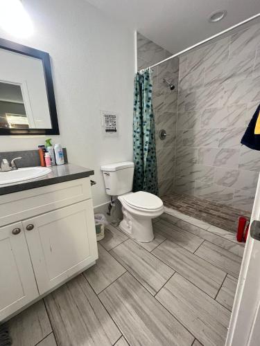 a bathroom with a toilet and a sink and a shower at We are in this together in Santa Ana