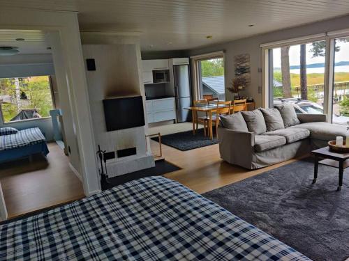 a living room with a couch and a fireplace at Cottage by the sea in Turku