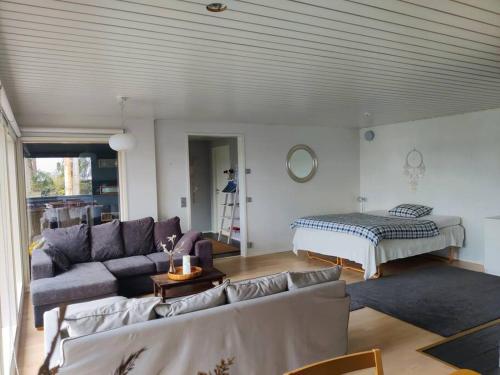 a living room with a couch and a bed at Cottage by the sea in Turku
