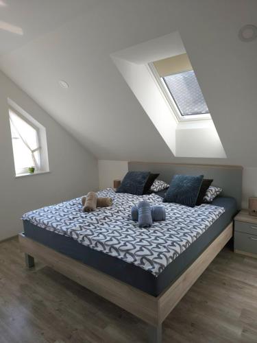 a bedroom with a bed with two teddy bears on it at Prima Countryside Apartments in Žirovnica