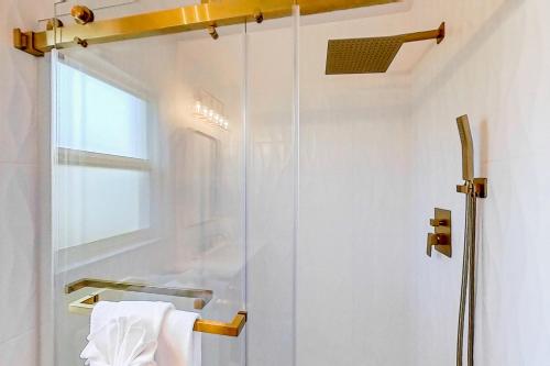 a shower with a glass door in a bathroom at Tropical Vibe in Dunedin