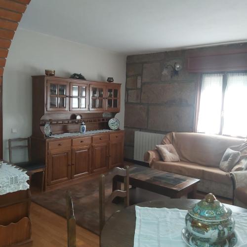 a living room with a couch and a table at Casa do Soalheiro in Castanheiro