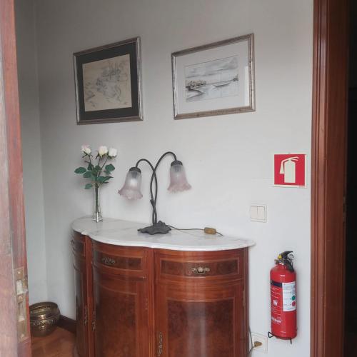 a sink in a room with two pictures on the wall at Casa do Soalheiro in Castanheiro