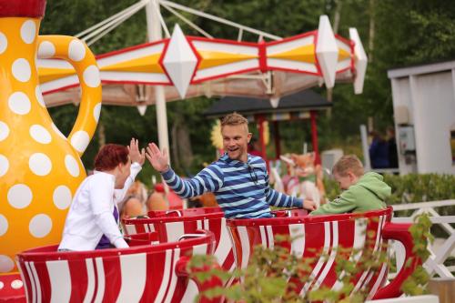 a man and two children riding on a train at Nallikari Seaside Aalto Apartments in Oulu