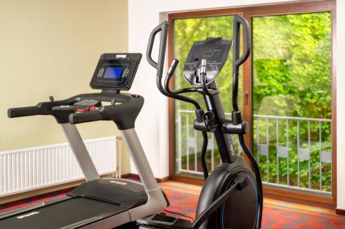 a treadmill with a cell phone on it next to a window at City Hotel Meckenheim in Meckenheim