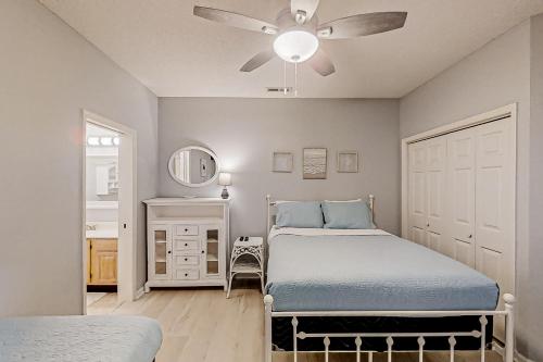a bedroom with two beds and a ceiling fan at Tidewater Dream in North Myrtle Beach