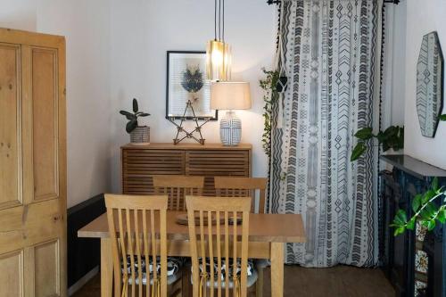 a dining room with a wooden table and chairs at Large Home Sleeps 6 Central Location Free Parking in Plymouth