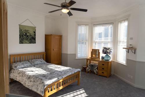1 dormitorio con 1 cama y ventilador de techo en Large Home Sleeps 6 Central Location Free Parking en Plymouth