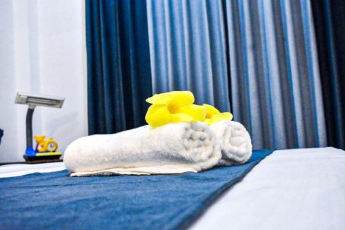 a pile of towels sitting on top of a bed at TwinsTop Villa in Minuwangoda