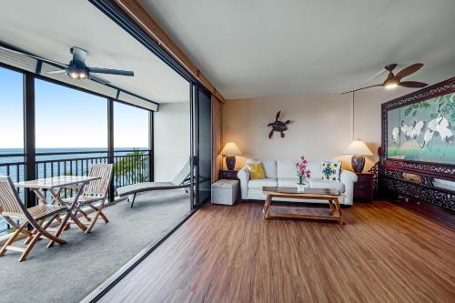a living room with a couch and a table at Kona Ali'i 502 in Kailua-Kona