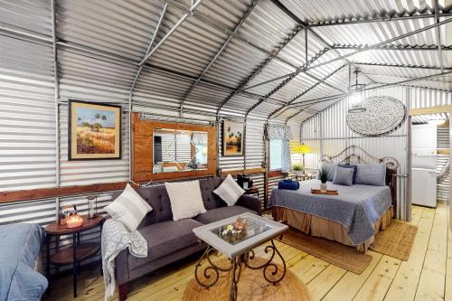 a living room with a couch and a bed at Waccasassa Wonder in Morriston